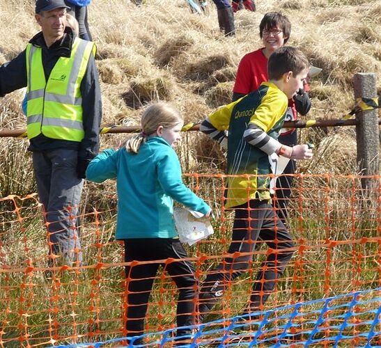 Tom running in at the finish with Eleanor and Sarah watching